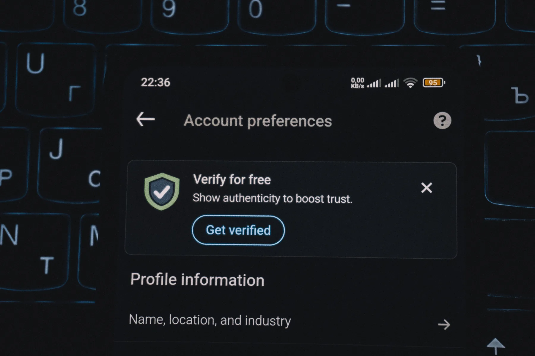 Phone screen showing an account preferences page with a Verify for free prompt to boost trust