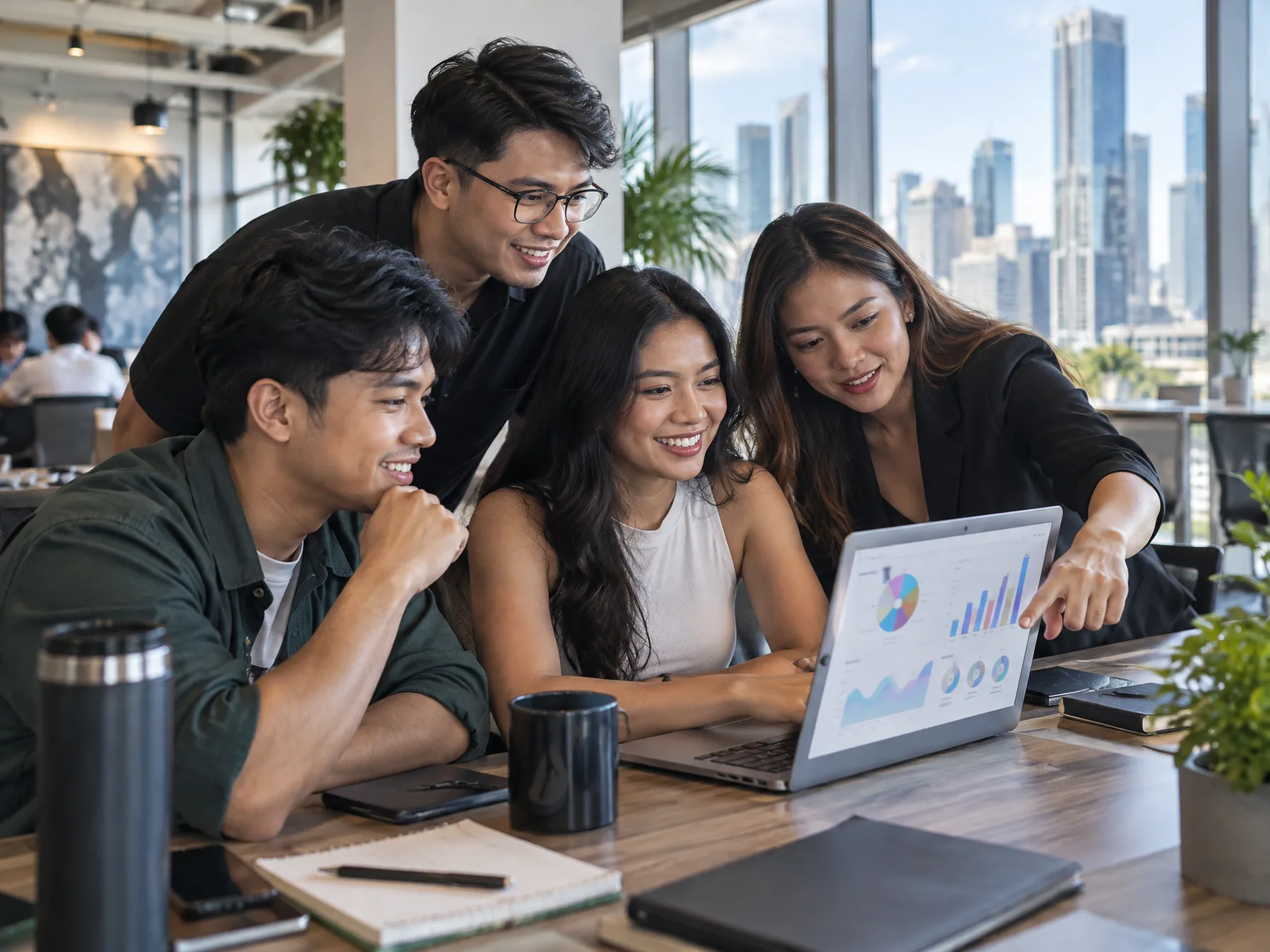 Four young Filipino startup founders and developers collaborating around a laptop in a bright Makati co-working space, one pointing at an abstract dashboard