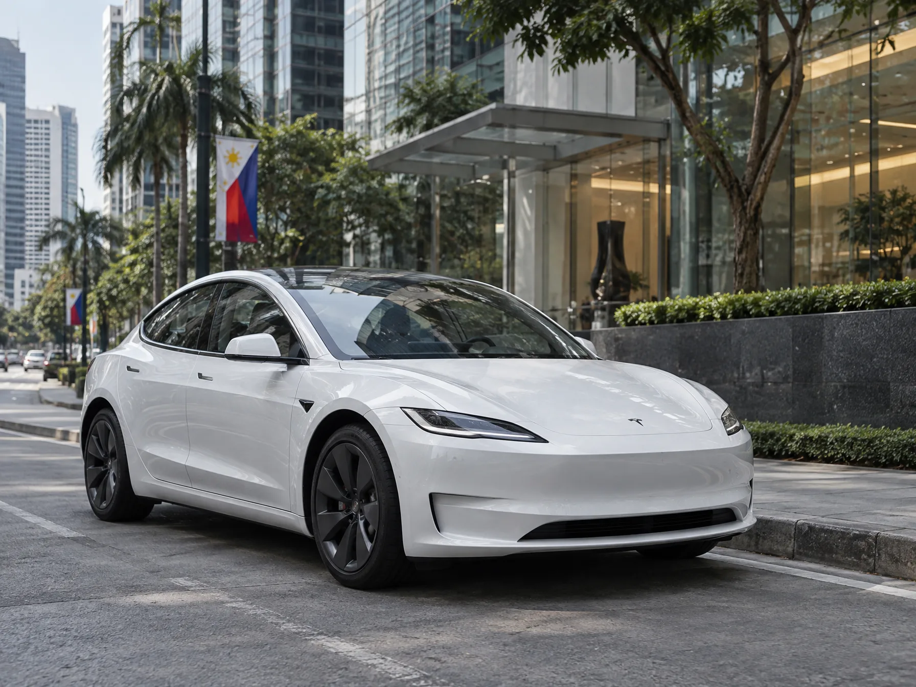 A Tesla Model 3 sedan parked outside a modern Taguig condominium tower in the late afternoon