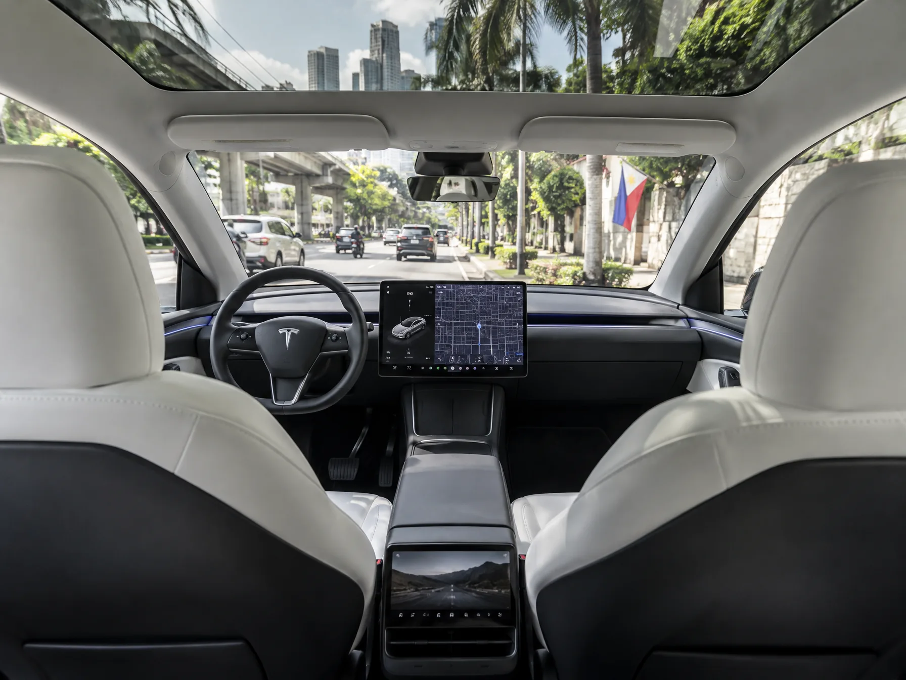 Tesla Model Y L front cabin with the large center touchscreen and minimalist dashboard
