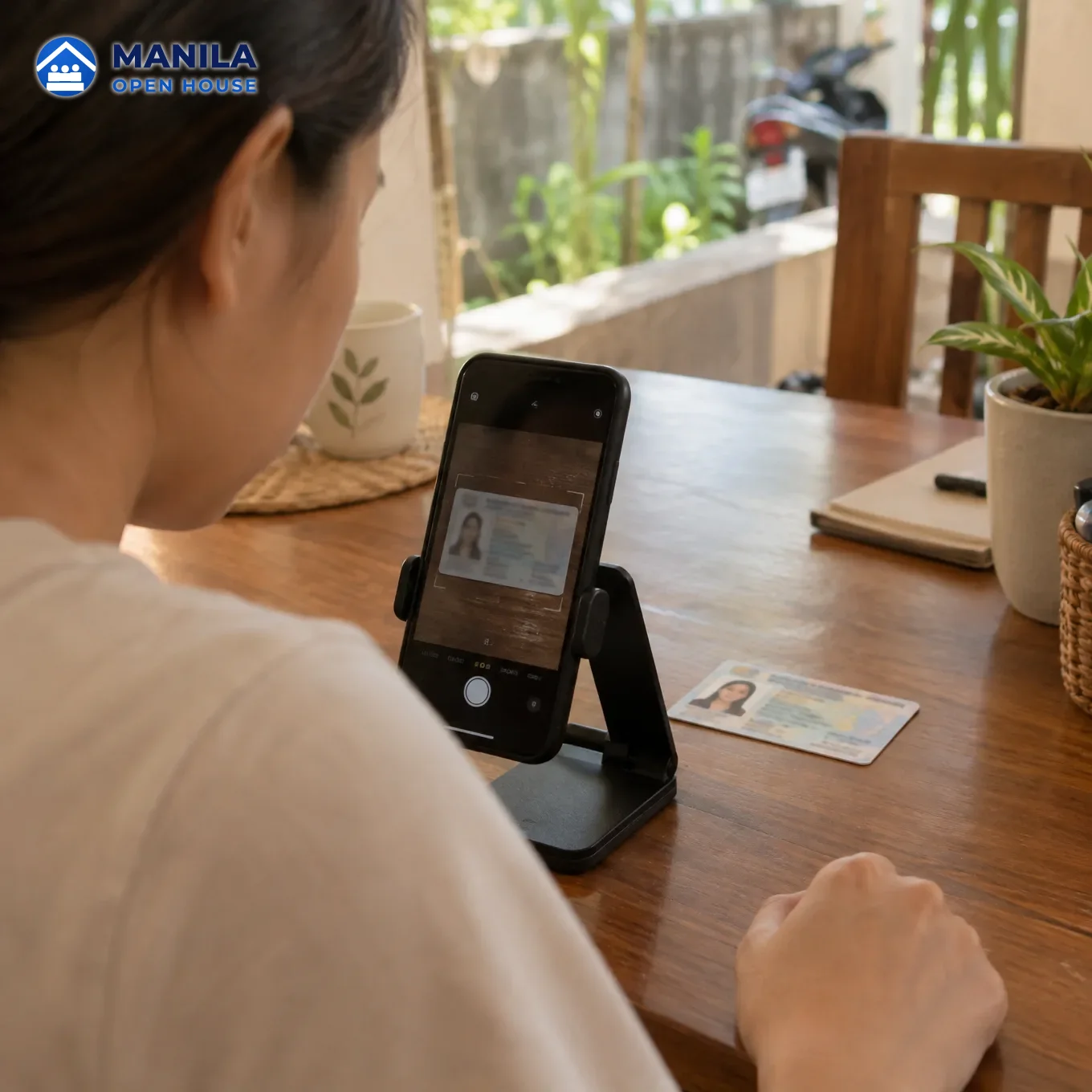 A phone on a stand scanning a generic ID card lying on a table