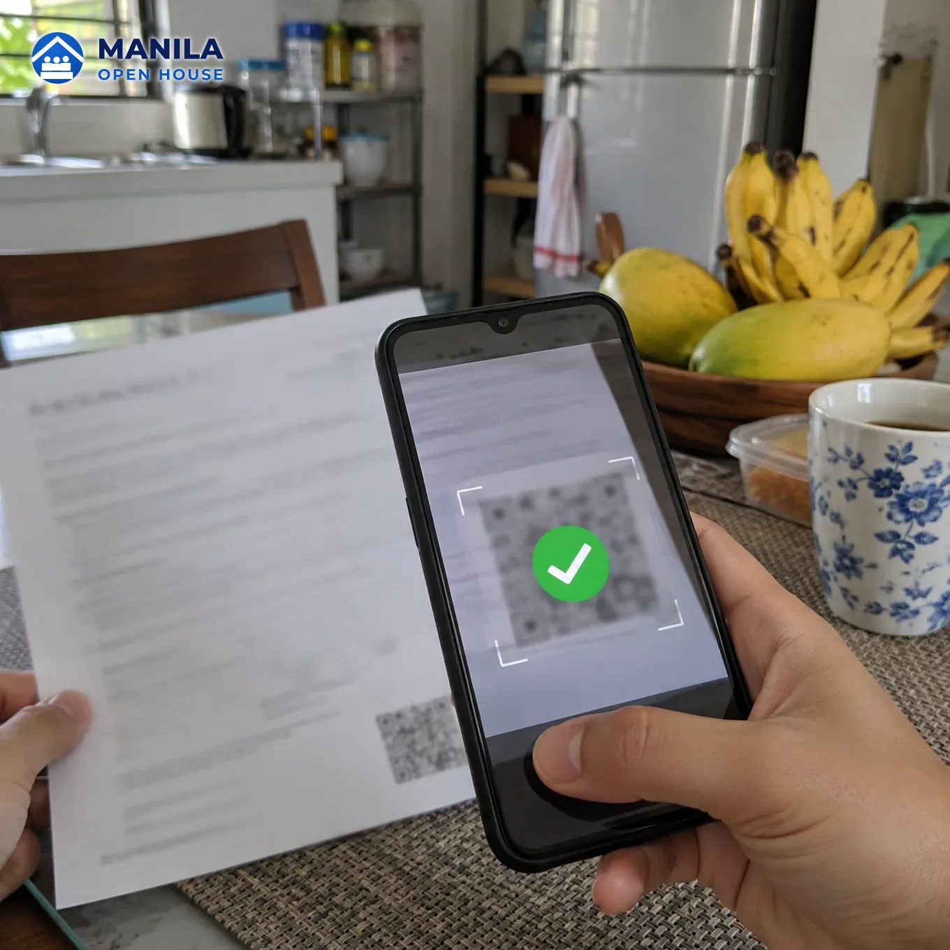 A phone camera framing a blurred QR square at the bottom of a document