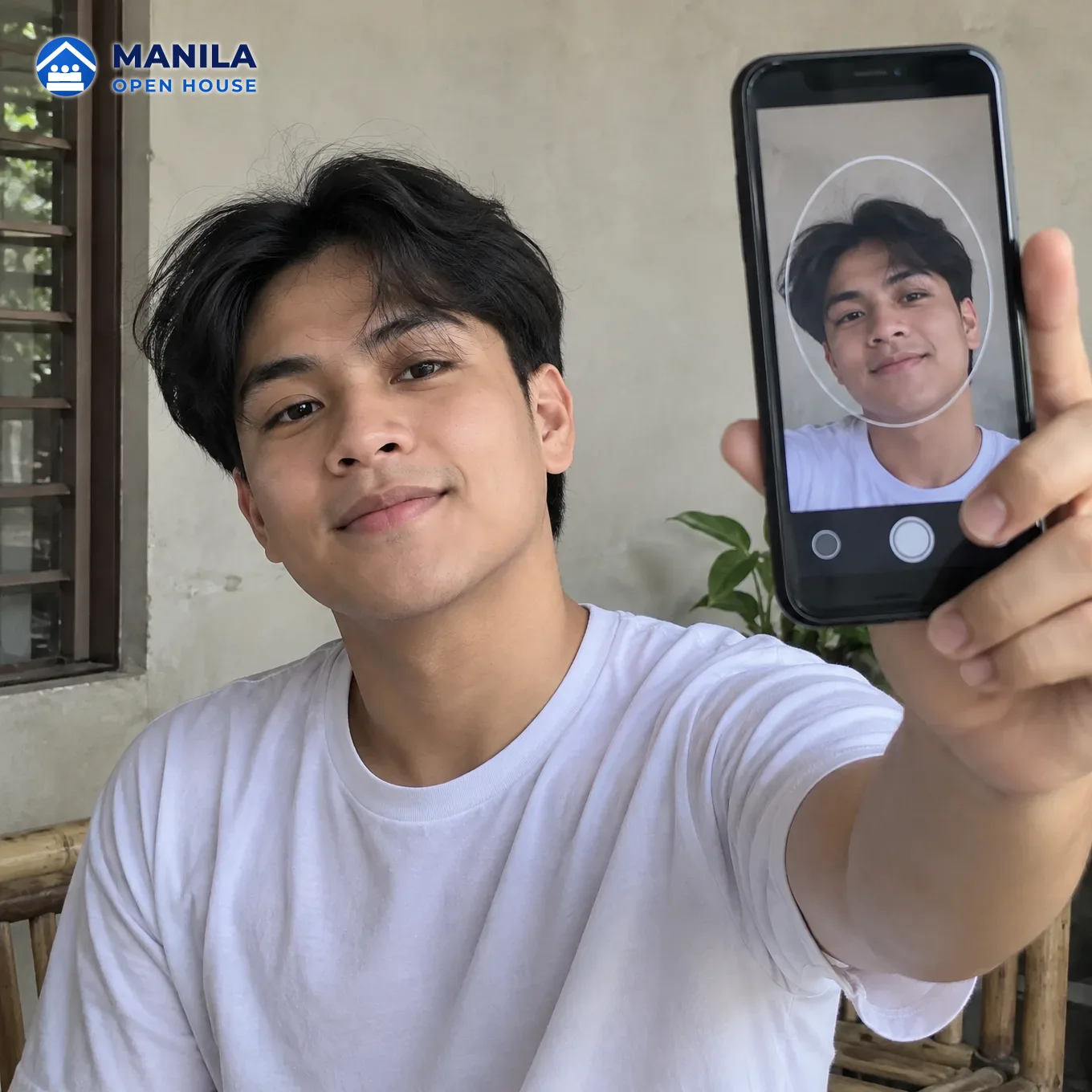 A young Filipino man holding a phone at arm length with a face-frame overlay